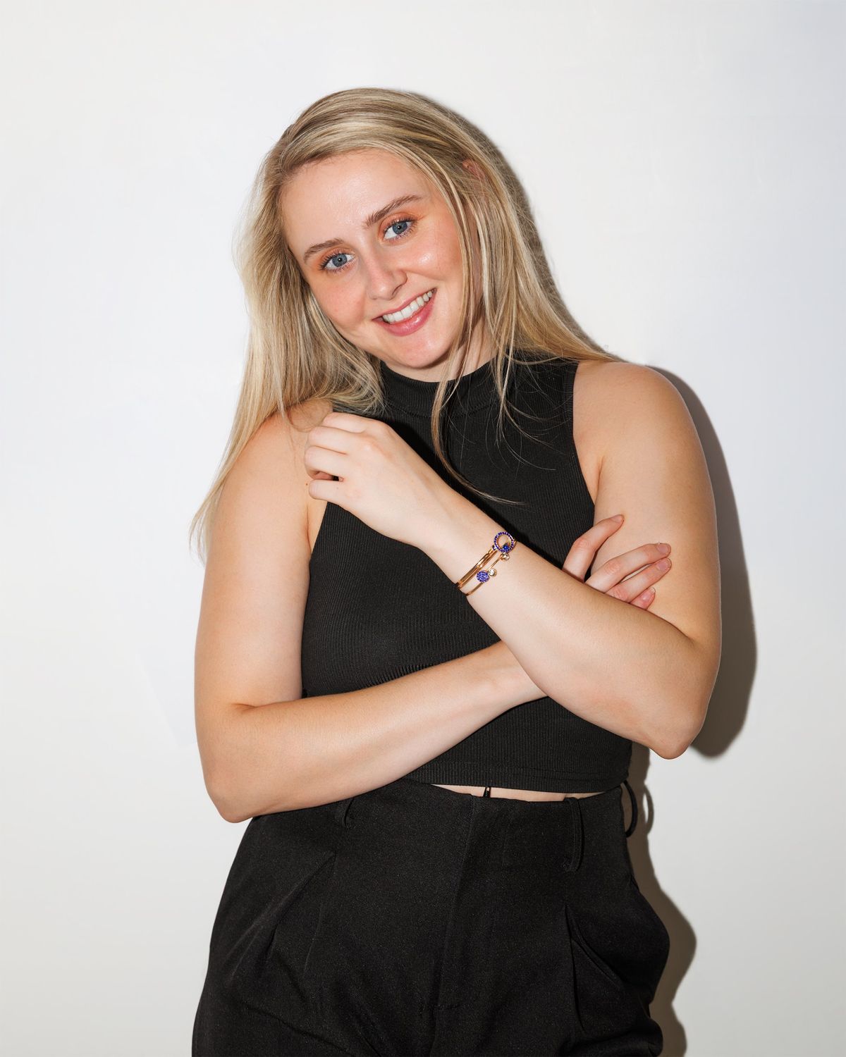 Portrait of Victoria smiling, arms folded
